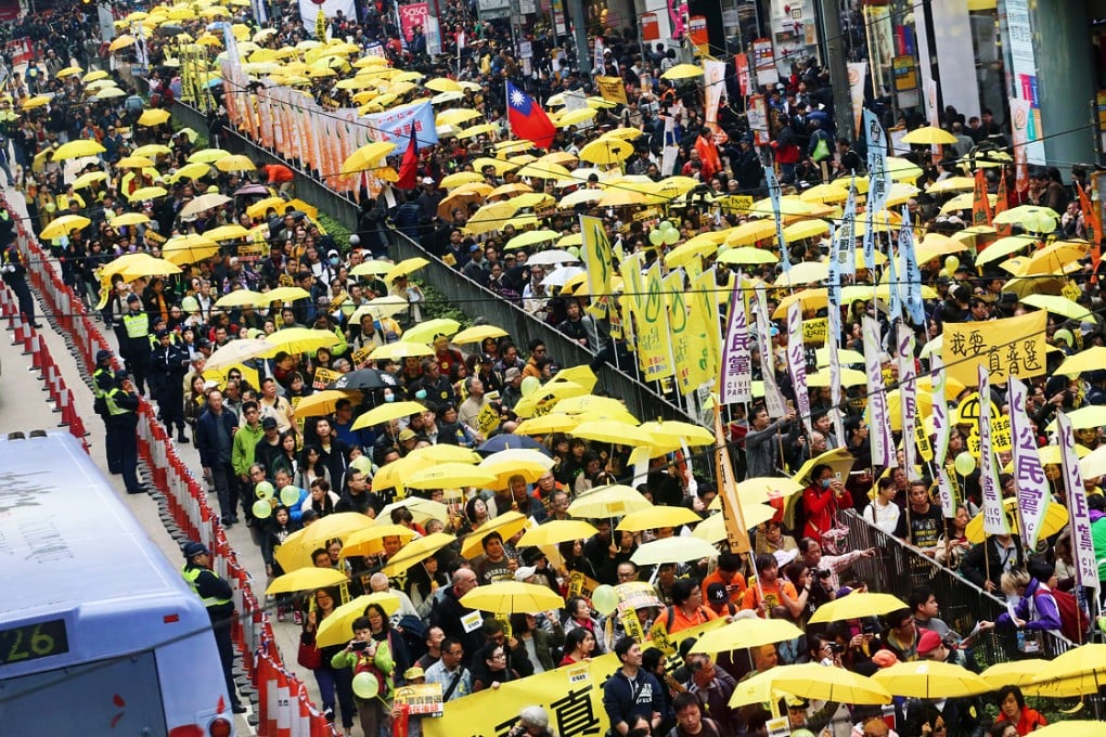 Thousands of pro-democracy campaigners unfurled yellow umbrellas for yesterday's march - but many stayed away. Photo: Felix Wong
