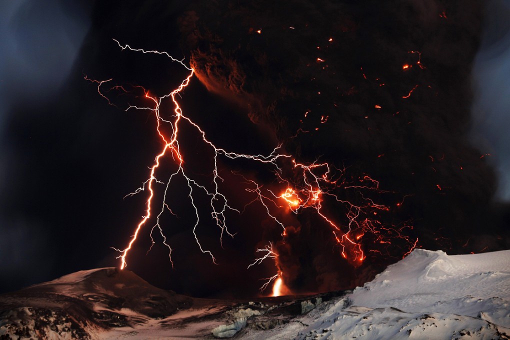 Lightning streaks across the sky as lava flows from a volcano in Eyjafjallajokul in 2010.