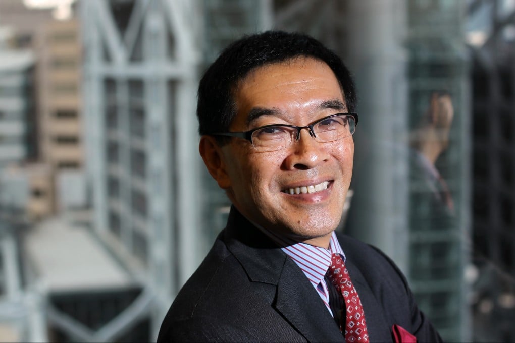 Hong Kong's Securities and Futures Commission chairman Carlson Tong  flashes a smile in his office in Cheung Kong Centre in the city's business district. Photo: Nora Tam