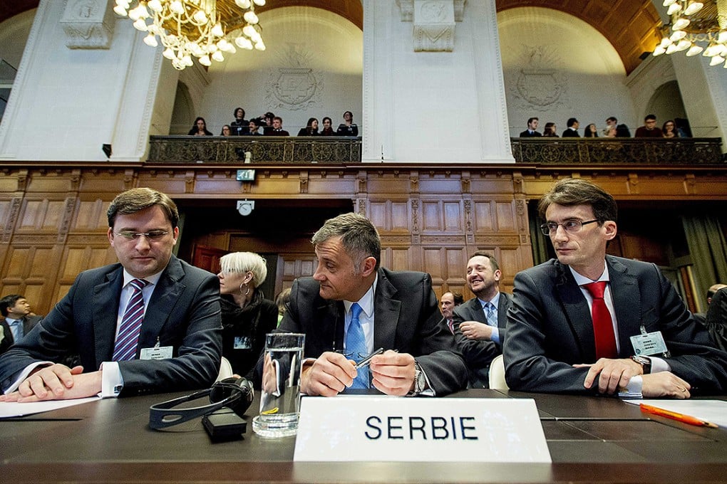 Serbian Justice Minister Nikola Selkovic, ambassador Petar Vico and Sasa Obradovic, head of the Serbain legal team, await the verdict on genocide claims brought up by Croatia against Serbia at the UN International Court of Justice in The Hague, The Netherlands. Photo: EPA