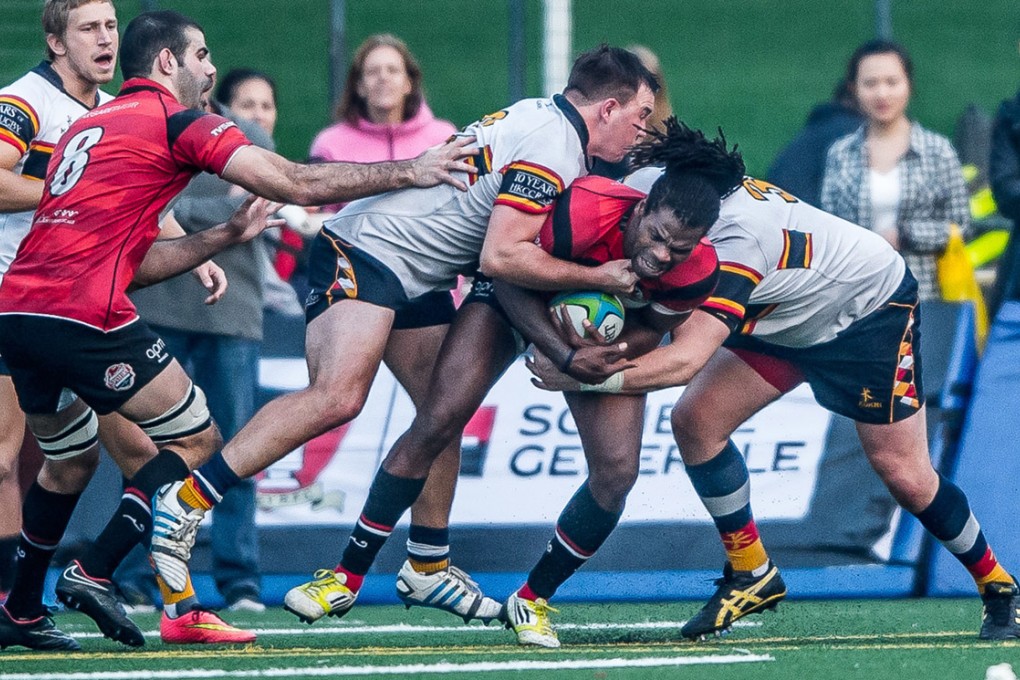 Dave Vainqueur of Valley gets wrapped up once more by the HKCC defence. Photos: HKRFU