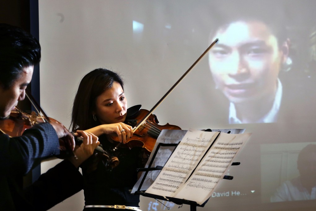 Hong Kong Philharmonic musicians perform Ian Ng’s piece Equal. The composer is featured on a screen through a Skype link. Photo: Nora Tam