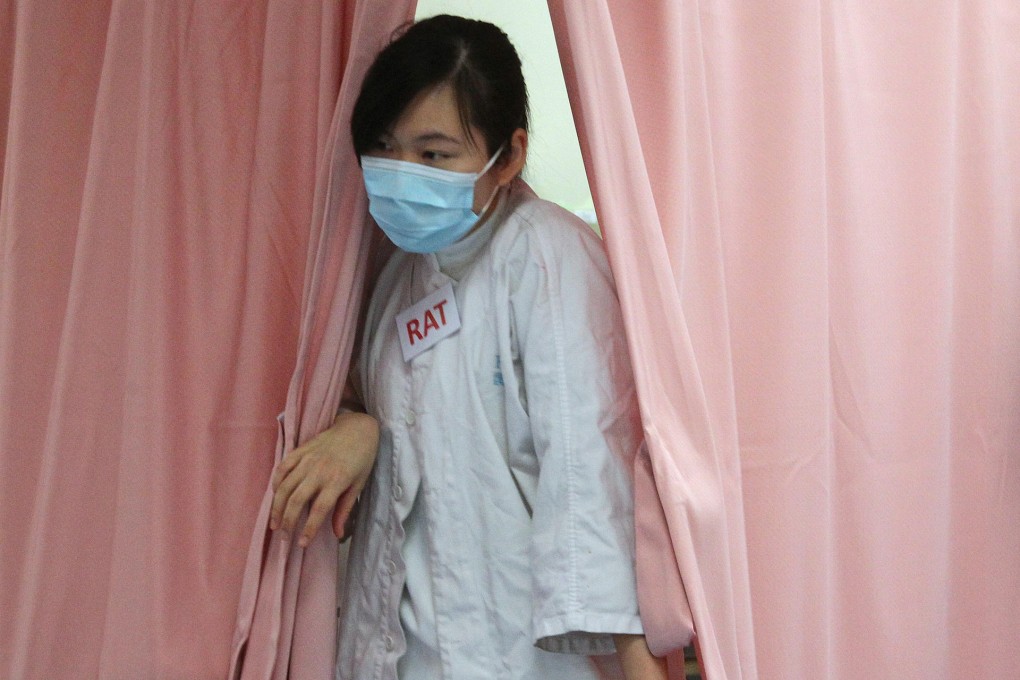 A nurse at Queen Elizabeth Hospital, which is admitting more than 550 influenza patients a day. Photo: Dickson Lee
