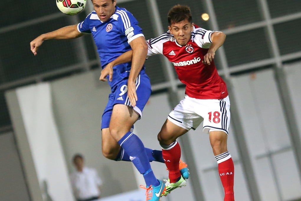 Eastern's Dylan Macallister (in blue) and South China's Kwok Kin-pong go for a header in a Hong Kong Premier League match at Mong Kok Stadium. Photo: Nora Tam