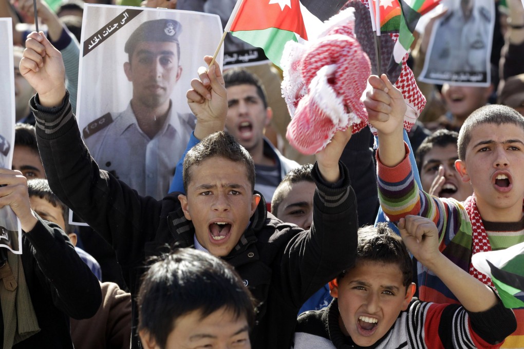 Young Jordanians shout slogans during a rally against the Islamic State group and in reaction to the burning alive of Jordanian pilot Maaz al-Kassasbeh by the group's militants. Photo: AFP