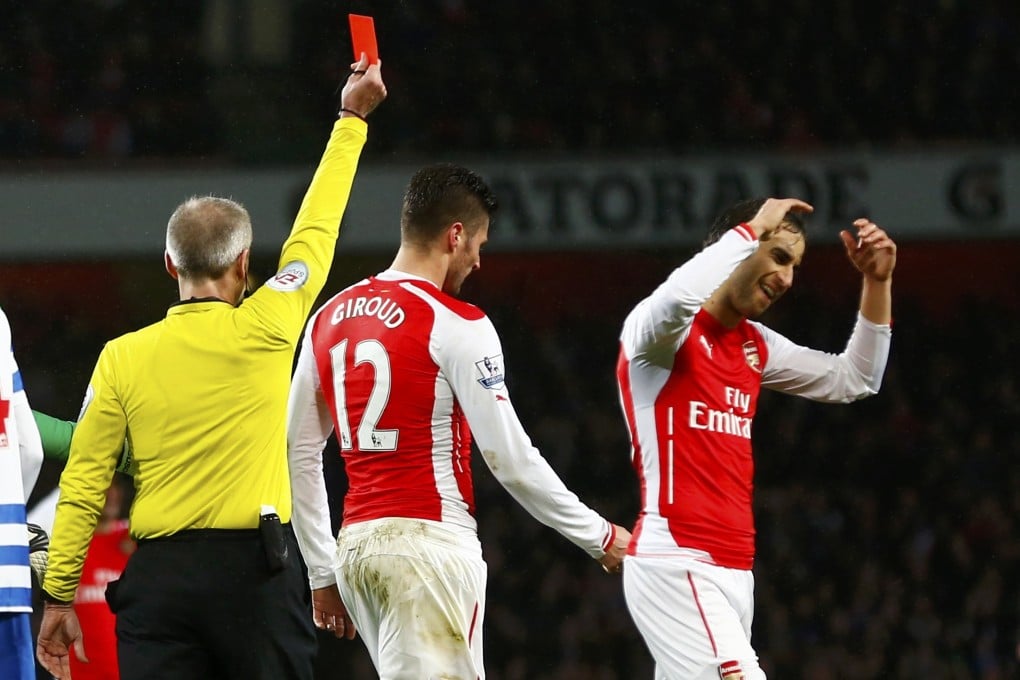 Referee Martin Atkinson shows Arsenal's Olivier Giroud a red card in their EPL match against Queens Park Rangers. Photo: Reuters