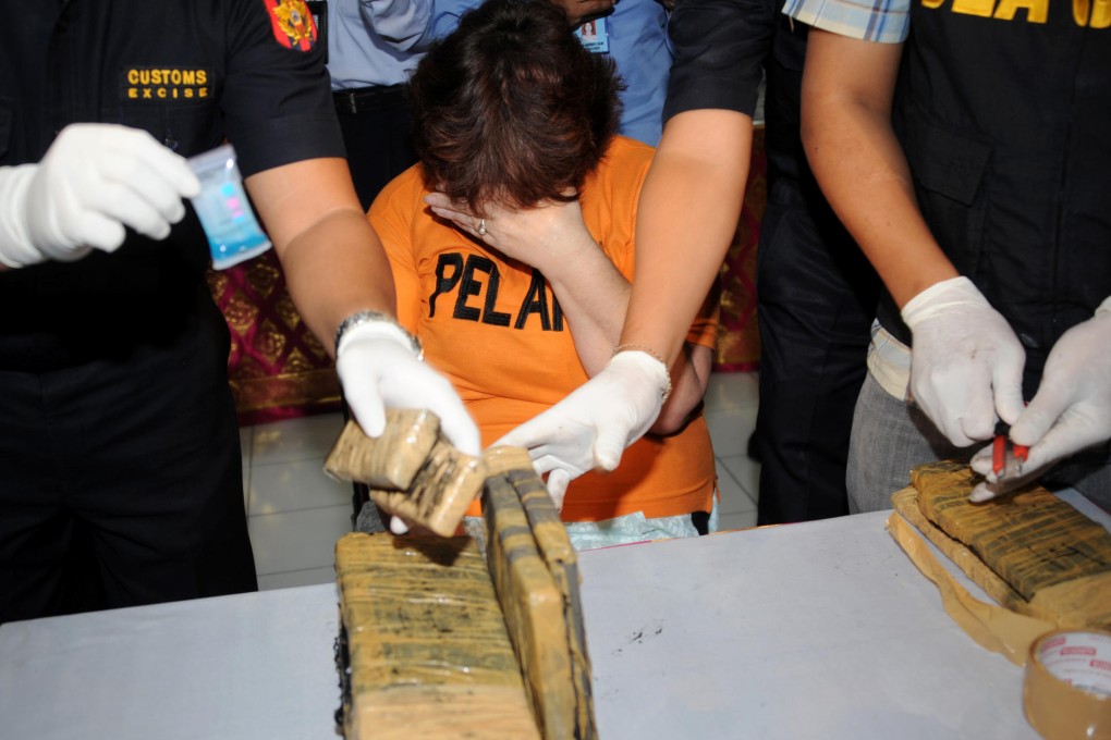 A suspected cocaine smuggler at Bali airport. Photo: AFP