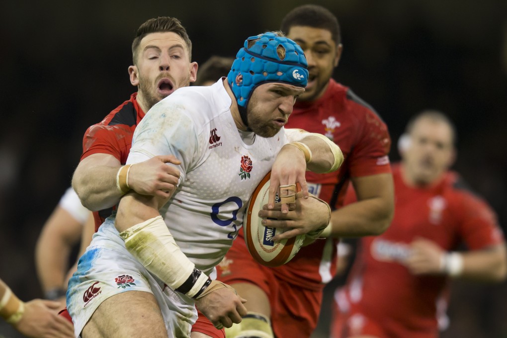 England's James Haskell attempts to break clear of Wales' Alex Cuthbert. Photo: AP