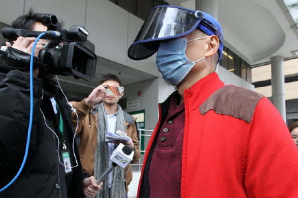 Dr Stephen Chow kept covered outside court. Photo: Edward Wong