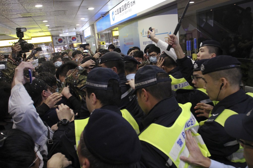 Protesters and police clash in Tuen Mun yesterday during a rally against parallel-goods trading. Photo: Dickson Lee