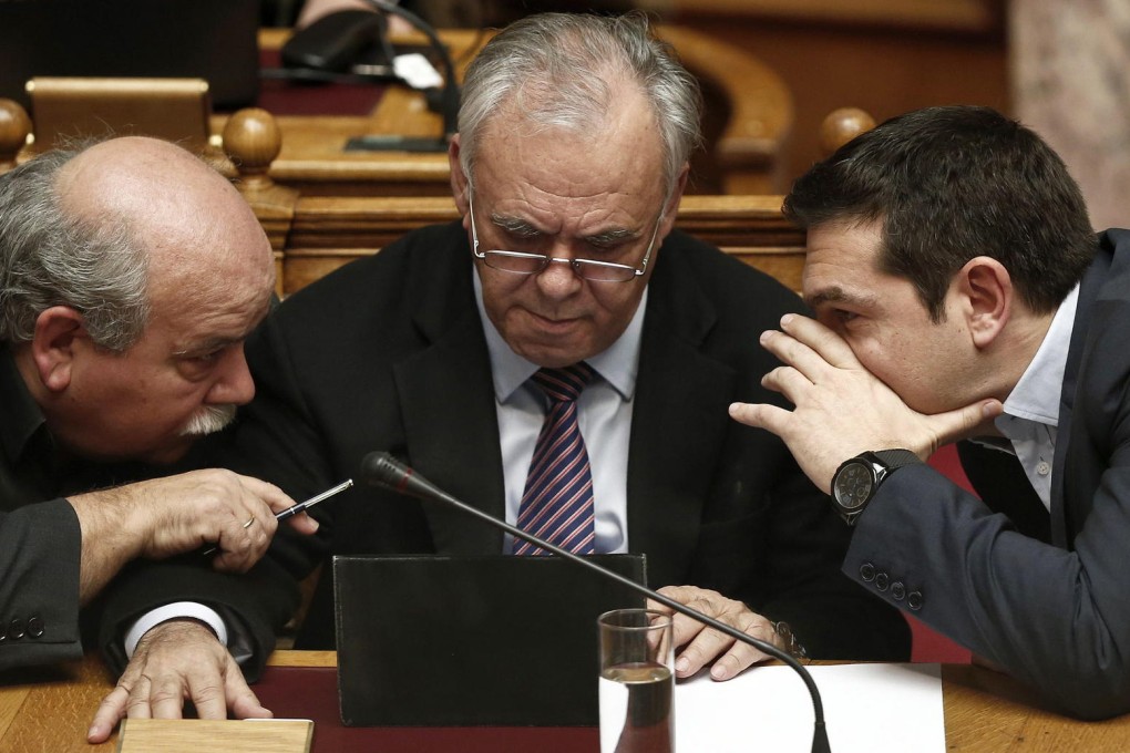 Prime Minister Alexis Tsipras (right) speaks to Deputy Prime Minister Giannis Dragasakis (centre) and minister Nikos Voutsis. Photo: Reuters