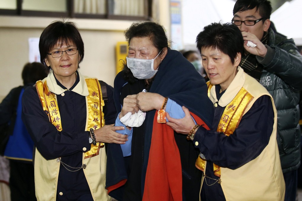 Bereaved families of victims of last week's TransAsia Airways plane crash. A Buddhist ceremony was held in Taipei on Monday night. Photo: Reuters