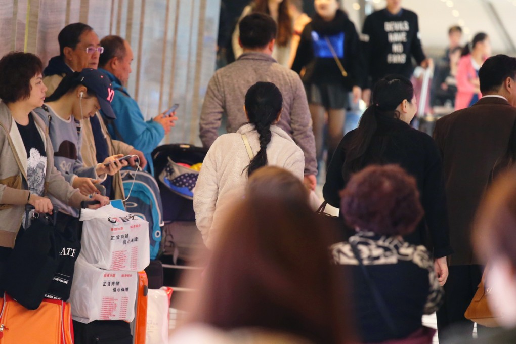 Solo travellers shop for Chinese New Year at Sha Tin New Town Plaza. Hongkongers have different takes on the phenomenon. Photo: K.Y. Cheng