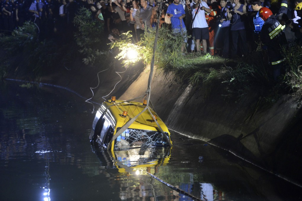 A school van is lifted from a reservoir after an accident in Xiangtan, in Hunan province, last July, which killed 11 people, including eight children. Photo: Reuters