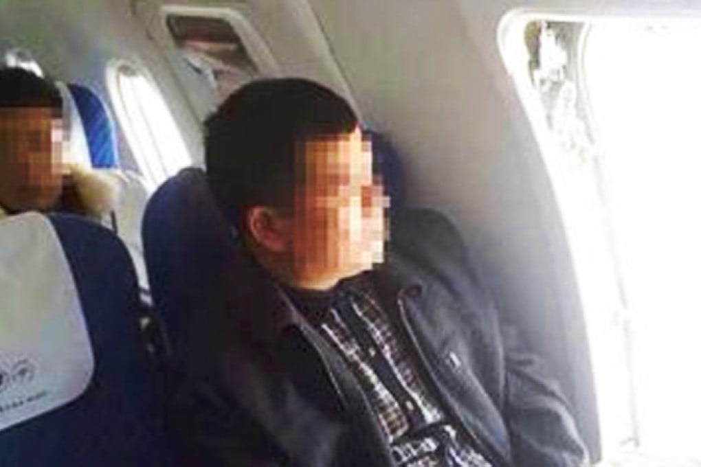 An image taken by a passenger of the man sitting in his seat after opening the aircraft's emergency exit on Monday. Photo: SCMP Pictures