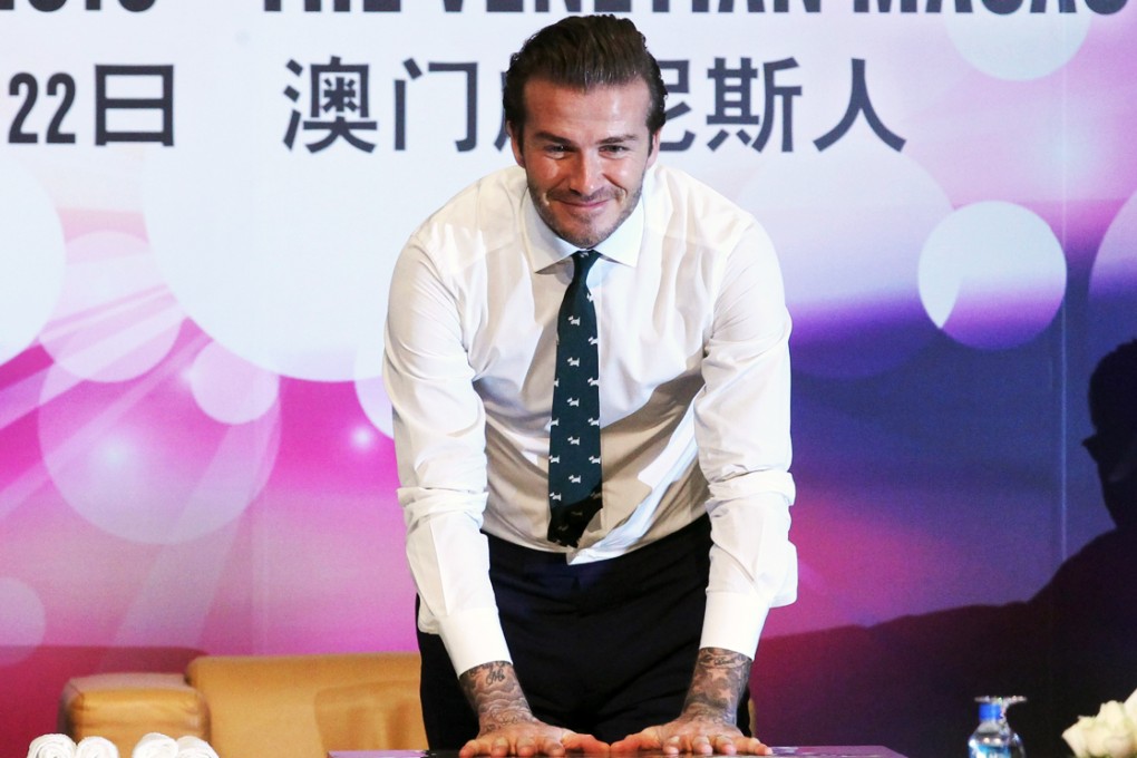 David Beckham leaves his handprints for posterity during a press conference at The Venetian Macao in November 22, 2013. Photo: Edward Wong