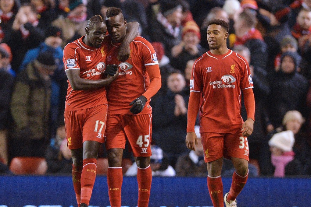 A stony-faced Mario Balotelli is congratulated. Photo: EPA