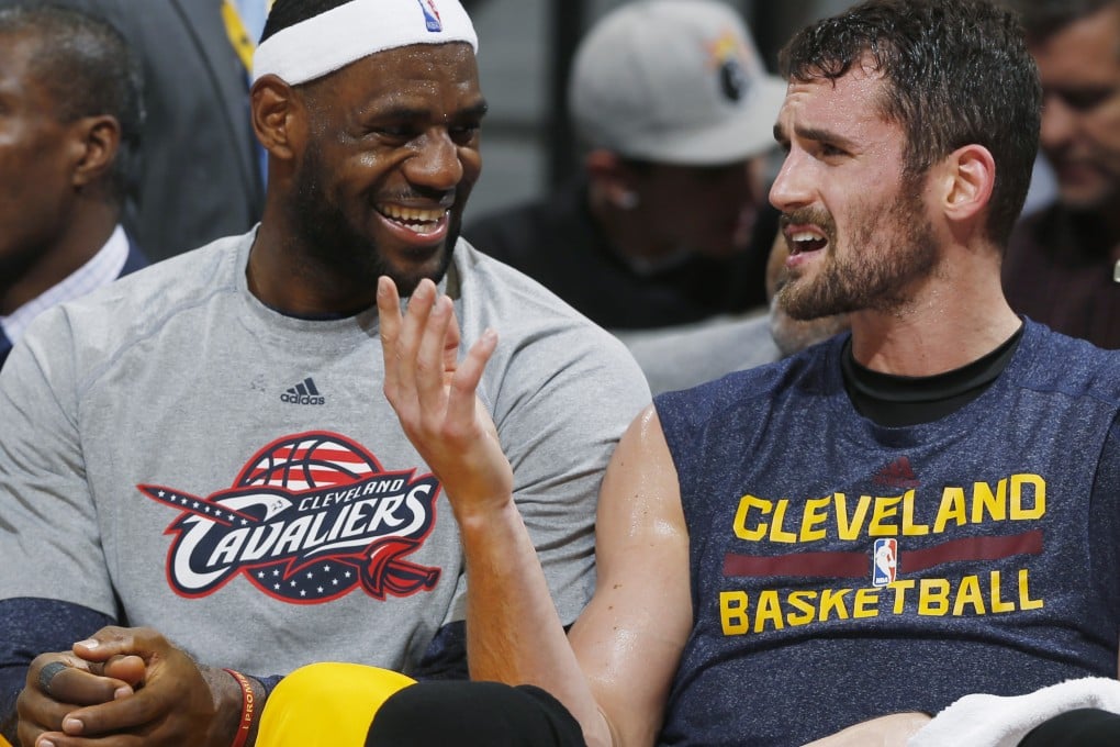 Cleveland Cavaliers forwards LeBron James and Kevin Love joke with each other on the bench. Photo: AP