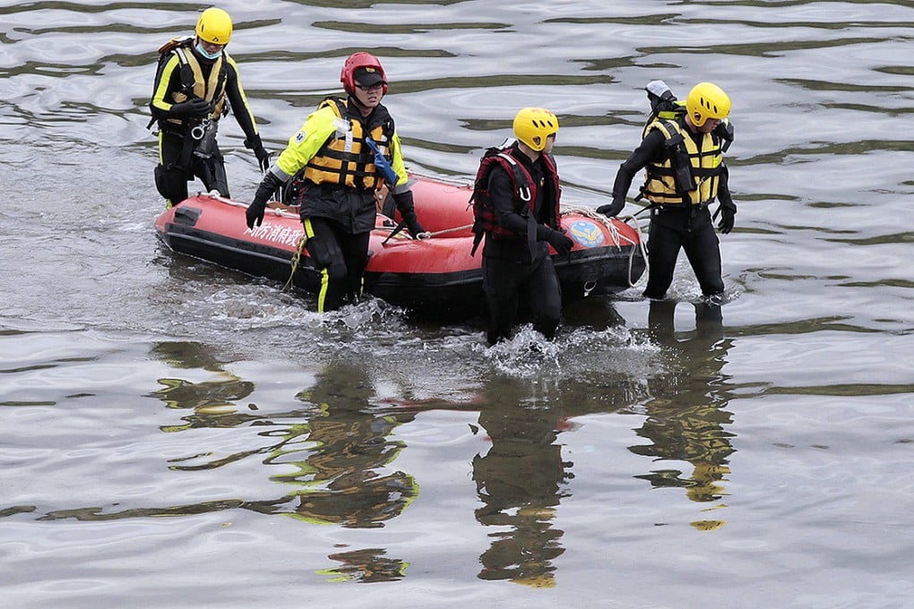 Rescue workers search the river near the crash site. Photo: AP