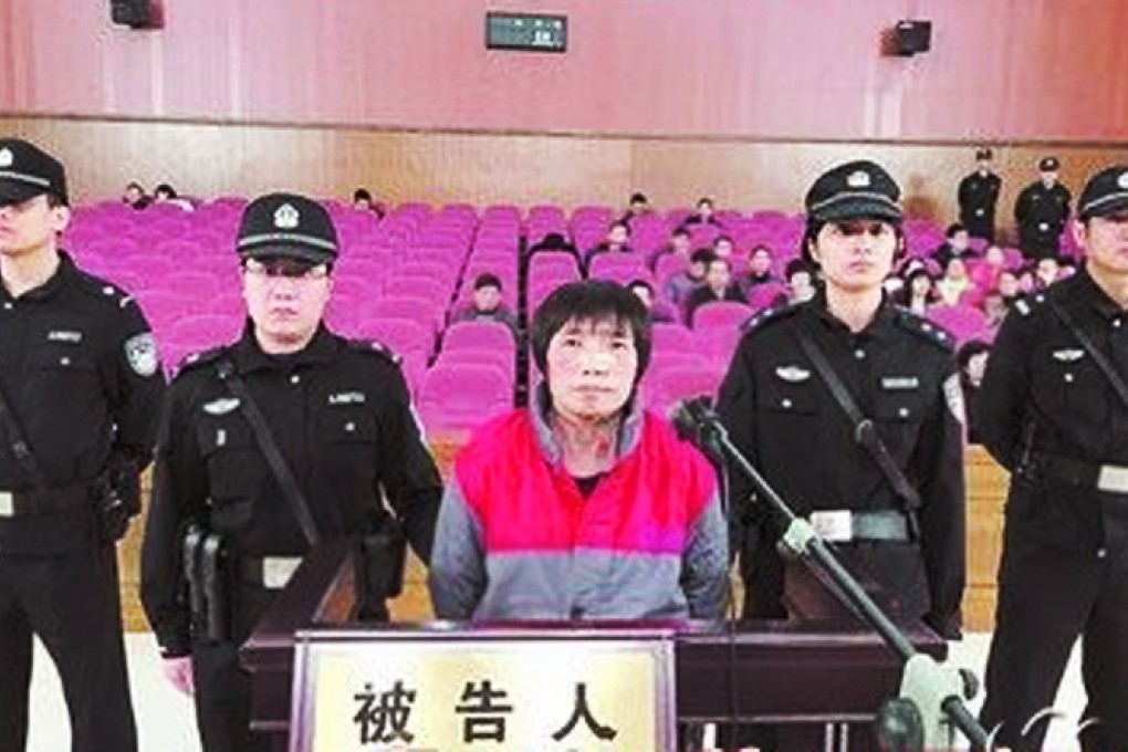 Wang Wenlin, pictured here flanked by police, owned shops, jewellery and department stores, hotels and entertainment venues. Photo: Xiamen Daily