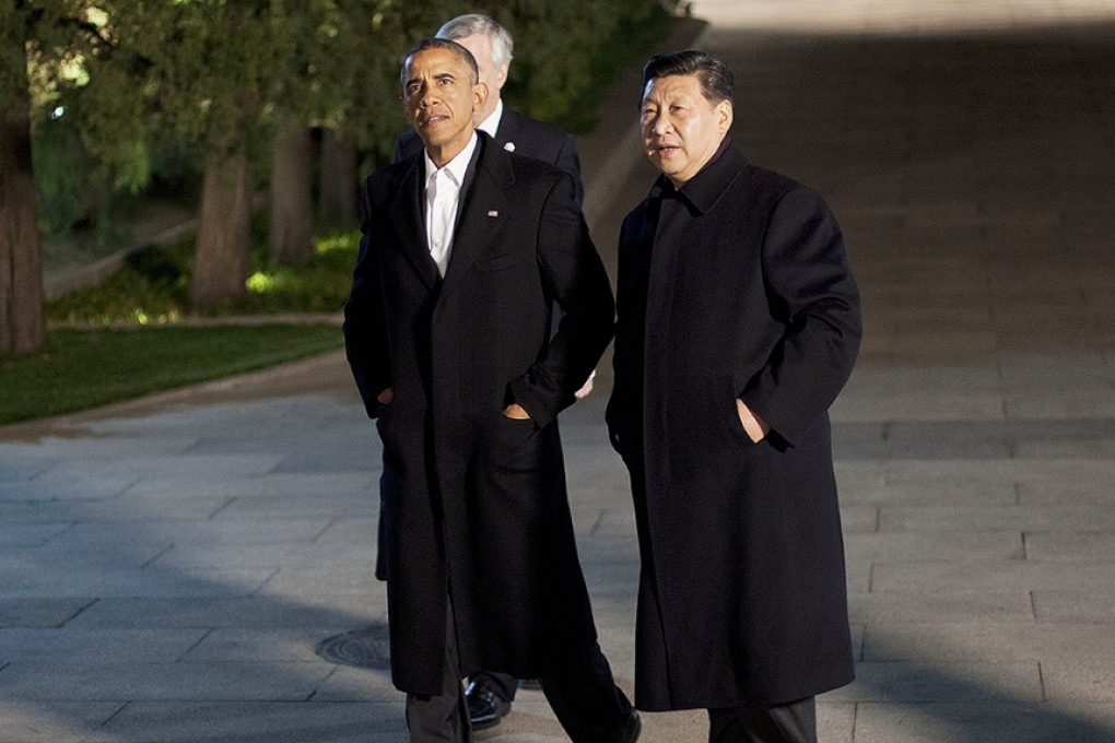 Xi and Obama walk together at the Zhongnanhai leaders compound in Beijing before a private dinner in November. Photo: AP