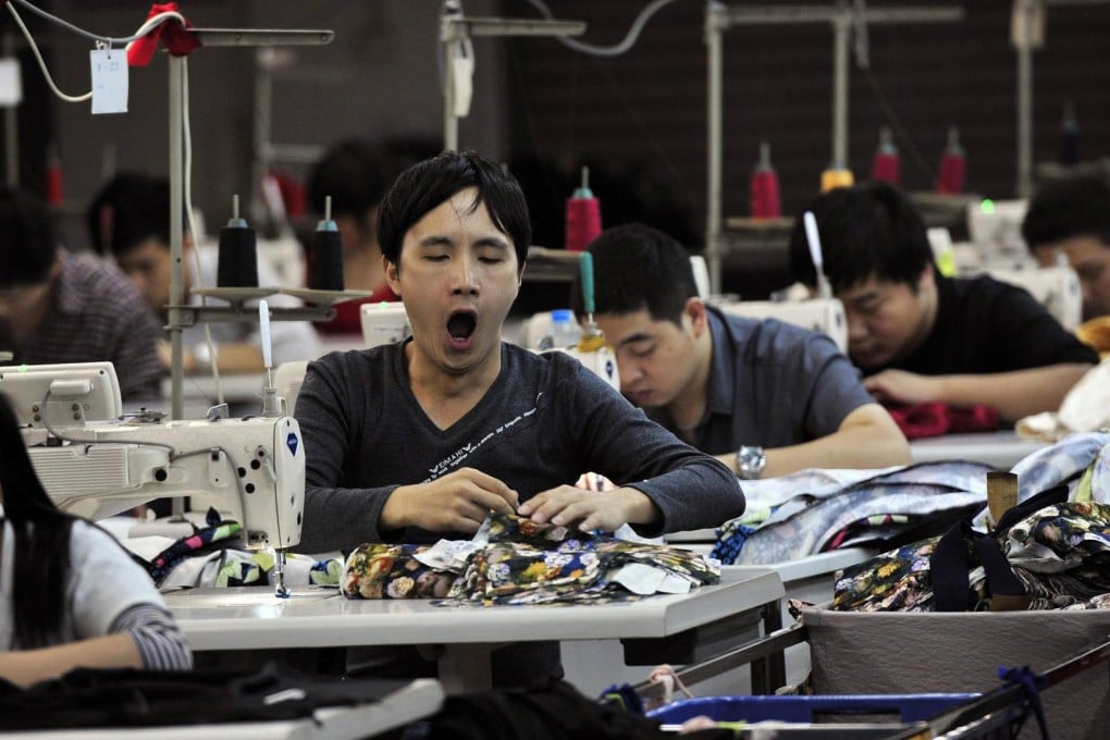 An employee yawns at a garment factory in Humen township, Guangdong province. Photo: Reuters