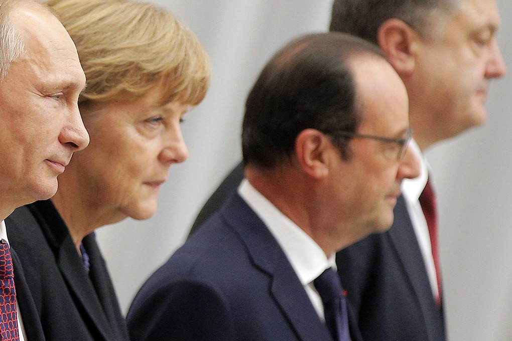 Russian President Vladimir Putin, German Chancellor Angela Merkel, French President Francois Hollande and Ukrainian President Petro Poroshenko pose during for a group photo during the Ukraine peace talks in Minsk. Photo: EPA