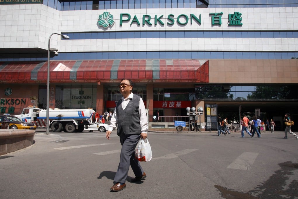 A shopper walks away from a Parkson Retail Group store in Beijing. Photo: Bloomberg