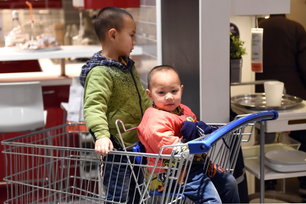 Two boys pictured at a furniture store in Beijing. The number of couples applying to have two children in China has been lower than expected. Photo: AFP