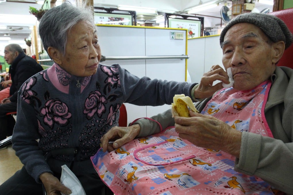 Lai Siu-yin, 85, visits her 90-year-old husband Fong Lo-kan in his private care home. The couple had been on a waiting list for a subsidised care home for both of them when he suffered a stroke in December. Photo: Dickson Lee