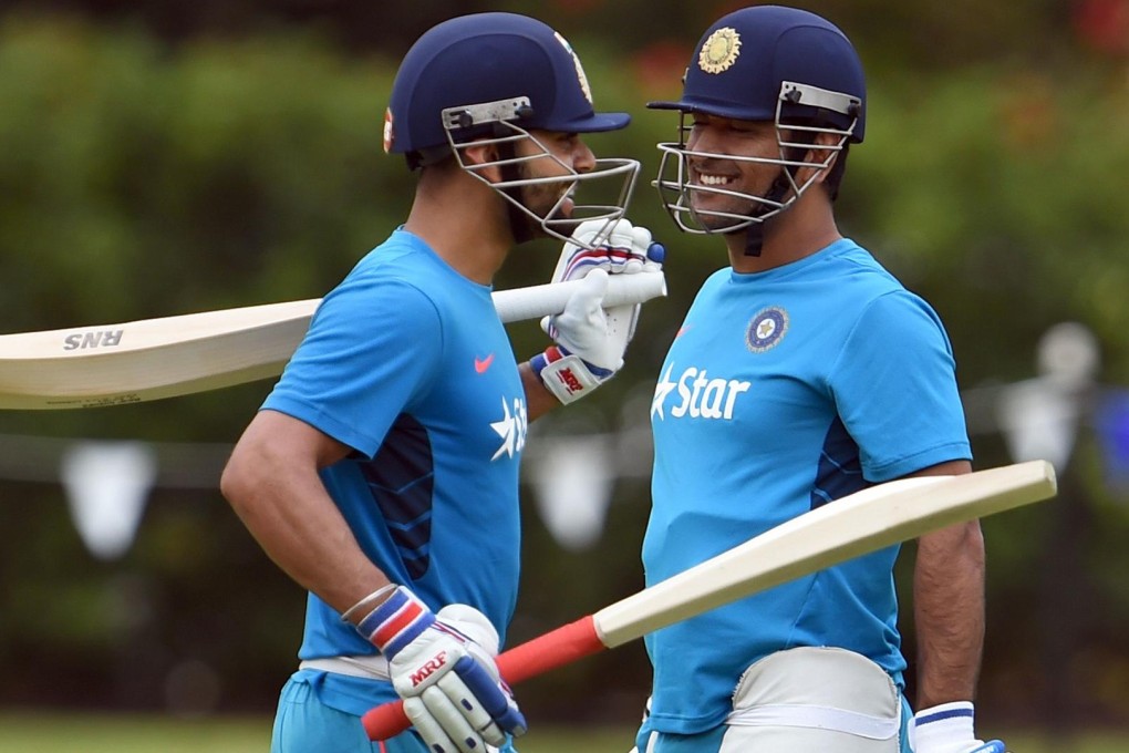 Indian one-day captain MS Dhoni (right) and Virat Kohli share a light moment during a training session in Adelaide on Saturday.Photo: AFP