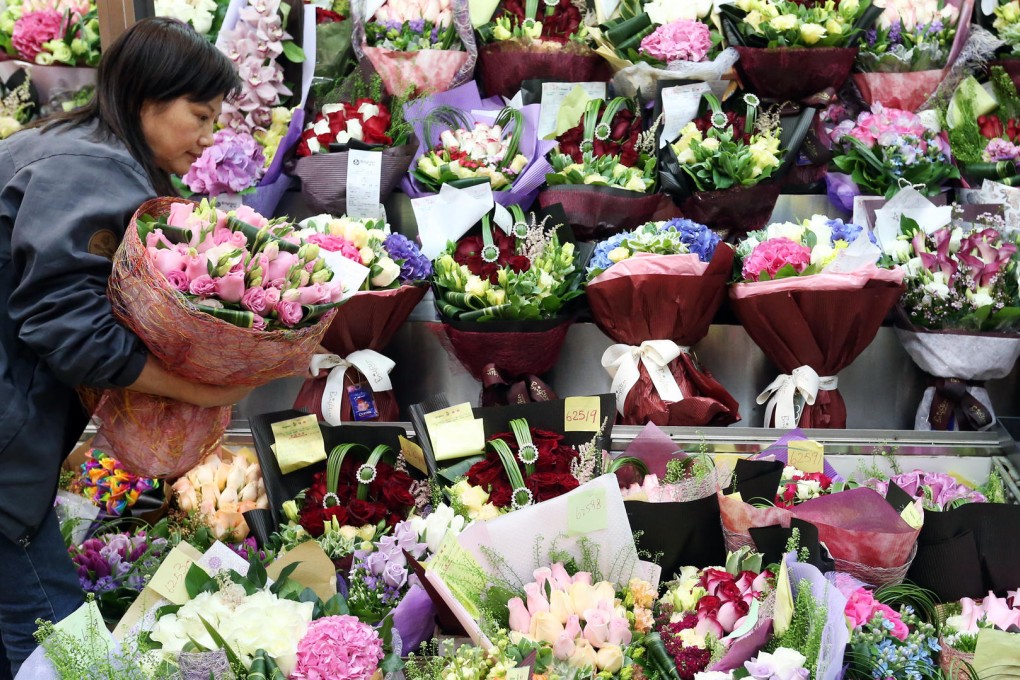 Roses are red, pink and even lilac at one florist's in Mong Kok yesterday, where Hongkongers were busy proving their top romantic credentials. Photos: K. Y. Cheng, May Tse