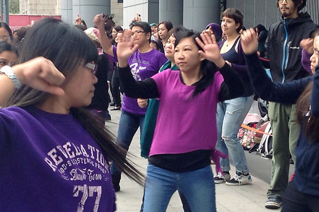 Erwiana Sulistyaningsih (centre) dances with the crowd gathered for the One Billion Rising event in Central to raise awareness for women's rights. Photo: Jennifer Ngo