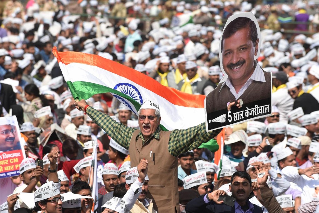 Supporters of the Aam Aadmi Party cheer their leader Arvind Kejriwal as he is sworn in as Delhi chief minister yesterday. Photo: AFP