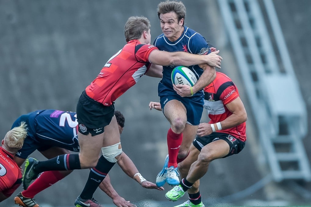 Hong Kong Scottish fullback Andrew Henderson tries to split the Valley defence in their Grand Championship semi-final at Shek Kip Mei. Photos: HKRFU