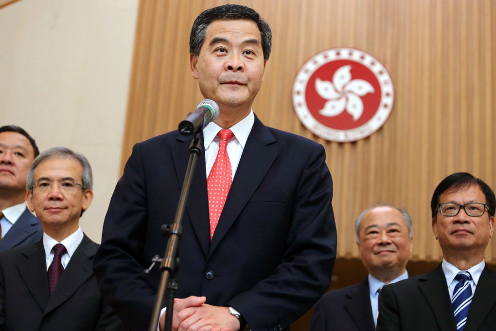 Exco members and Chief Executive Leung Chun-ying (center) meet media with other non-official members of the new Executive Council after its first meeting in Tamar in July 3, 2012.  Photo: Felix Wong