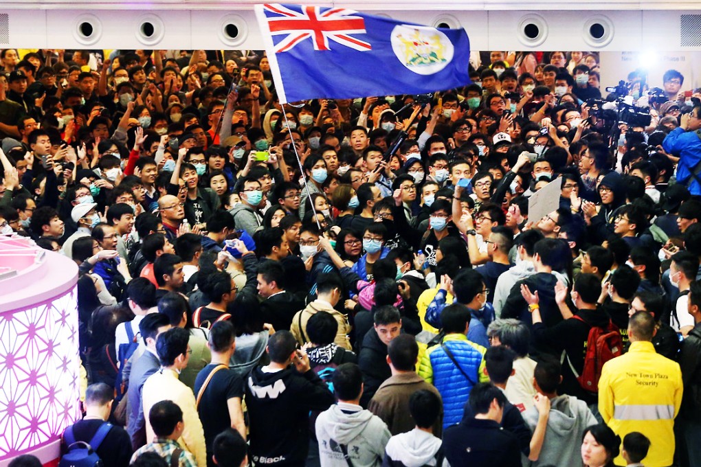Protesters, some waving the colonial-era flag, at the rally at the New Town Plaza in Sha Tin against parallel trading. Photo: David Wong