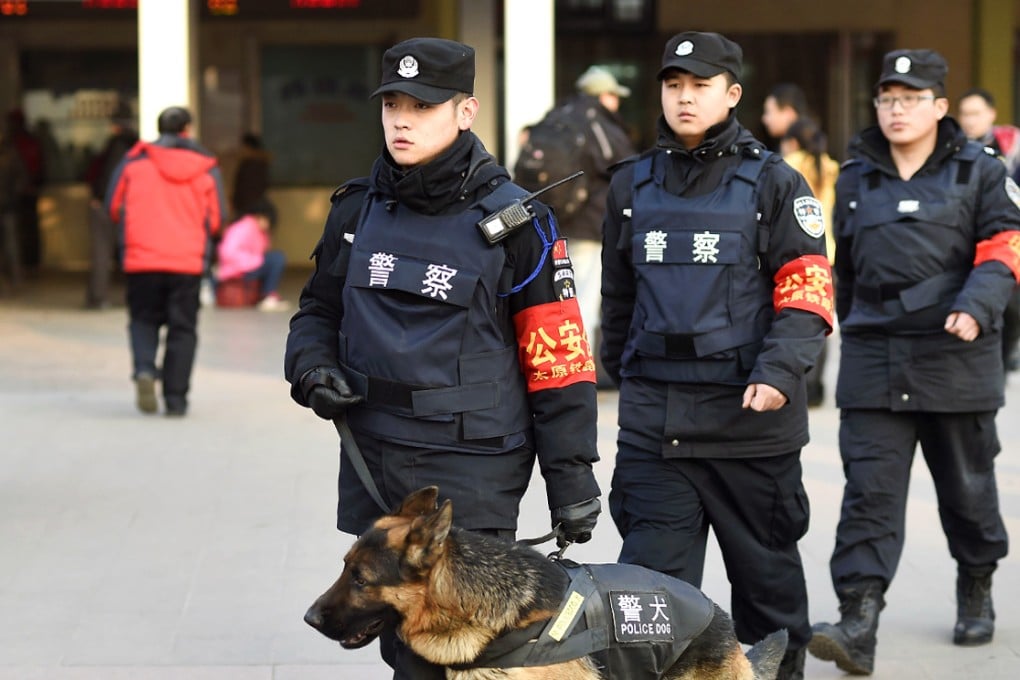 Police officers on patrol outside a railway station in Beijing. Photo: Xinhua