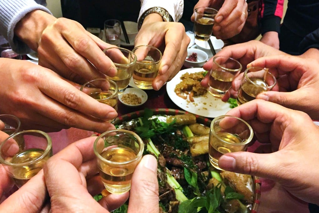 Revellers toast with rice wine at a restaurant in Hanoi. Photo: AFP