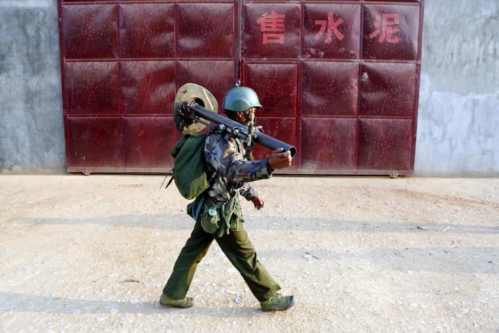 A Myanmese soldier carries a mortar in northeastern Shan state as he prepares for battle. Photo: EPA