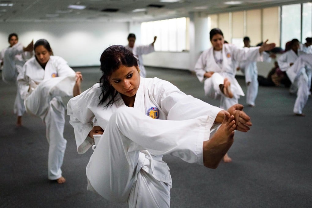 Indian policewomen practise kicks during a self-defence class in New Delhi as they prepare to take on the city's sexual predators. Photo: AFP