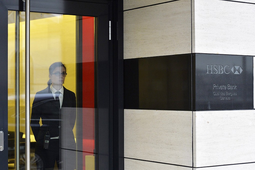 A security officer watches the entrance of HSBC Private Bank in Geneva. Photo: EPA