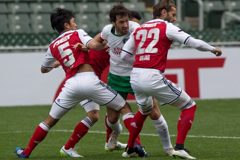 New York Cosmos' forward Raul Gonzalez (C) vies with South China Football Club's Chak Ting Fung (L) and Bojan Malisic (R). Photo: EPA
