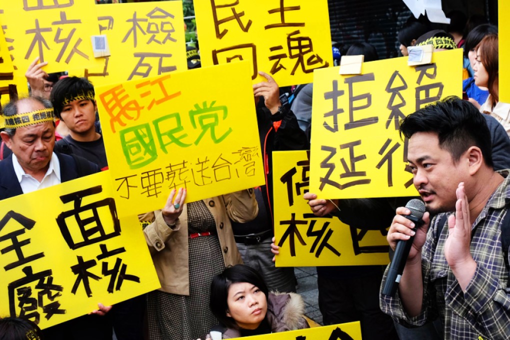 Anti-nuclear protesters display placards reading "shut down the fourth nuclear power plant" during a demonstration outside the ruling Kuomintang (KMT) party headquarters last year. Photo: AFP