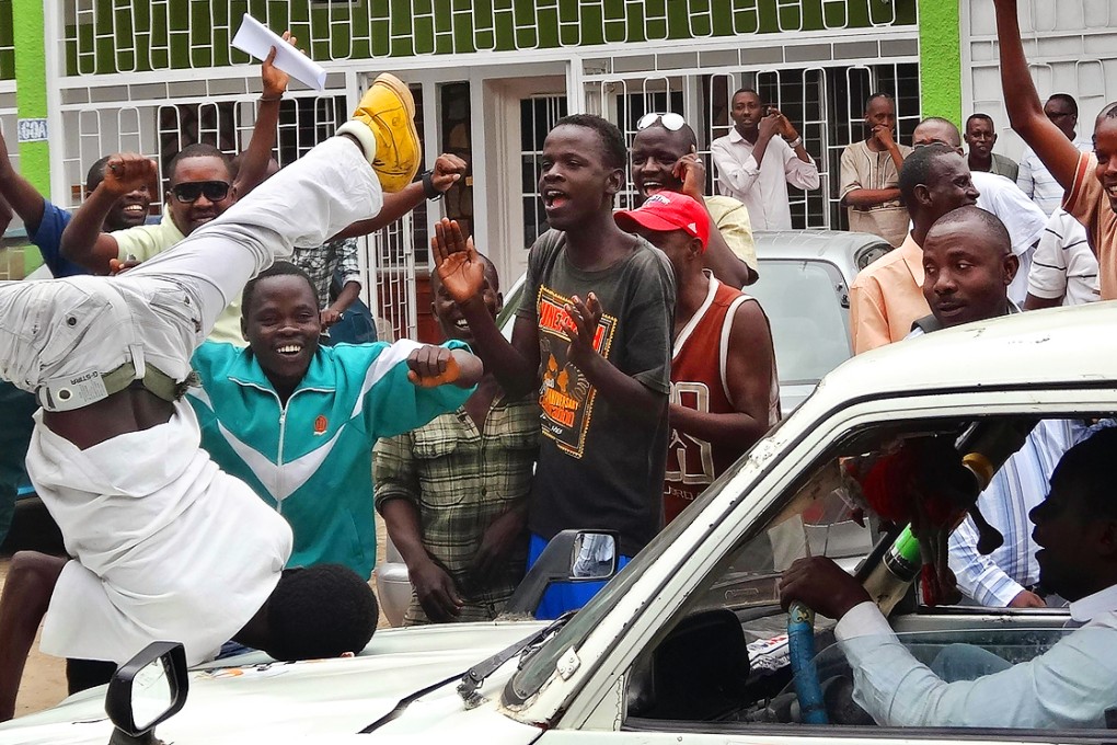 Burundians gather outside the headquarters of the popular independent African Public Radio (RPA) in Bujumbura on February 18, 2015 to welcome the release on bail of its director director accused of "complicity" in the murder of three Italian nuns. Photo: AFP