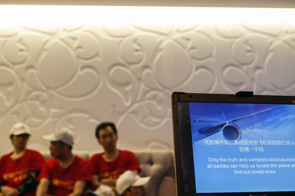 Chinese relatives of missing Malaysia Airlines Flight MH370 passengers sits as computer screen reads 'Only the truth and complete disclosure by all parties can help us locate the plane and find our loves ones' during press conference at a hotel in Seri Petaling near Kuala Lumpur. Photo: EPA
