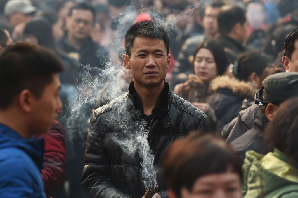 Worshippers pray in Beijing on the first day of the Lunar New Year. The vast majority of Chinese people do not benefit from cutting ties with their own society. Photo: AFP