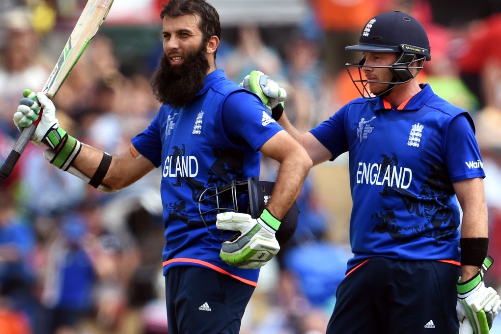 England's Moeen Ali gets a pat on the back from fellow batsman Ian Bell on reaching a century against Scotland in their World Cup match in Christchurch. Photo: AFP