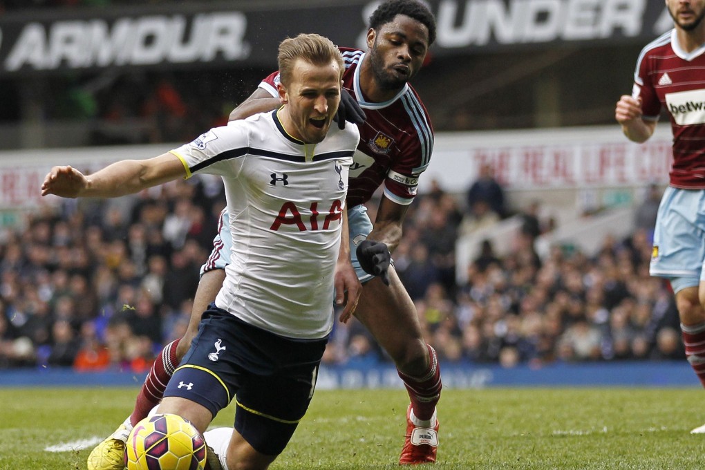Spurs' Harry Kane earns a match-saving penalty in the challenge of West Ham's Alex Song at White Hart Lane. Photos: AFP