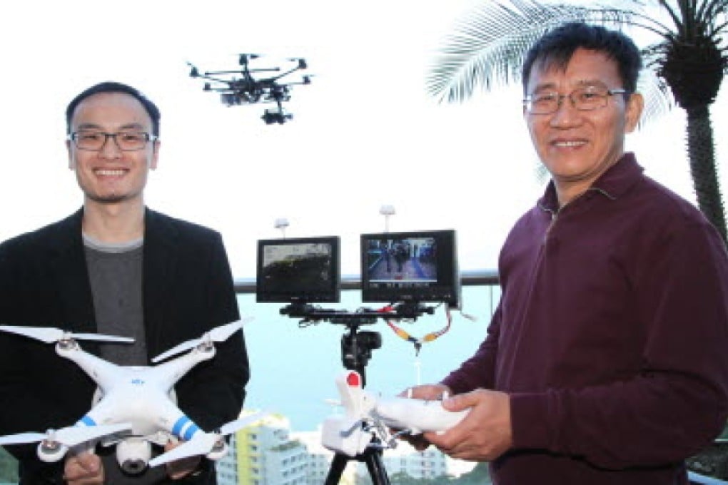 DJI founder Frank Wang Tao (left) and his mentor, Professor Li Zexiang, with some of the company's products. Photo: SCMP